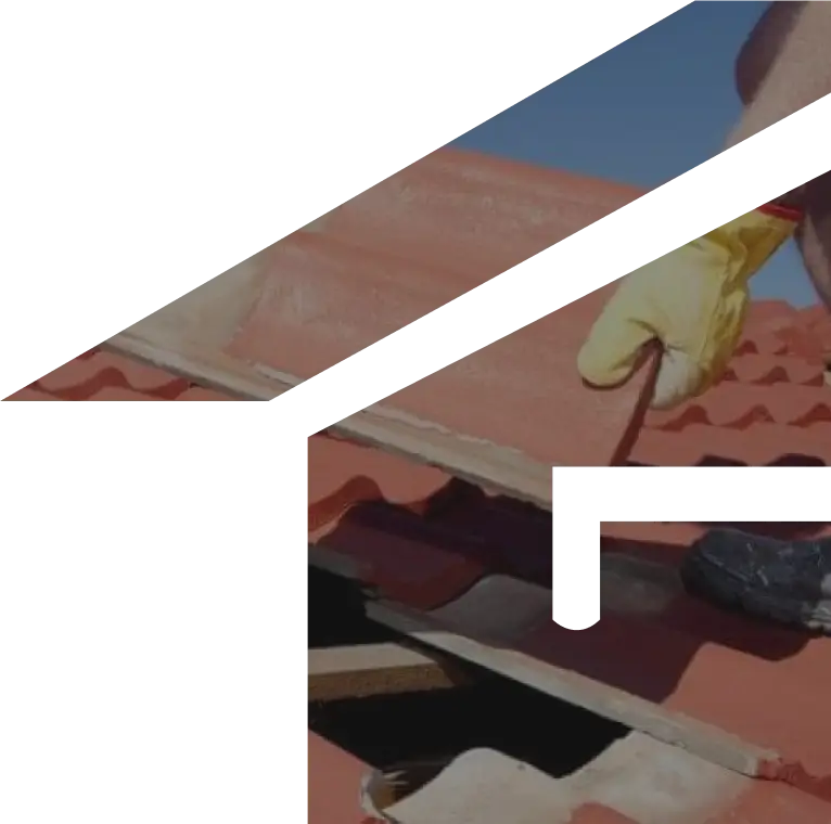 A person wearing a yellow glove uses a tool to repair or adjust red clay roof tiles under a clear blue sky—showcasing expert roofing Melbourne craftsmanship.