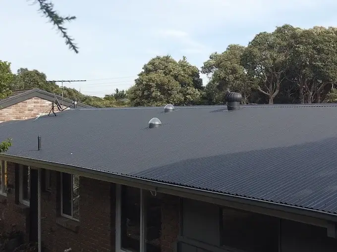 Recently replaced black metal roof on a Melbourne home with roof vents and skylights.