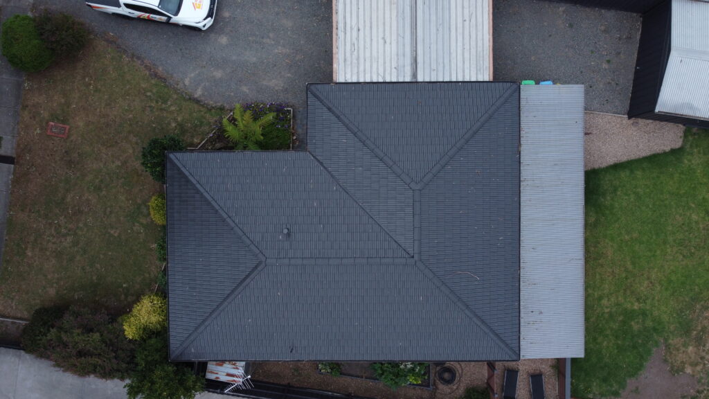 Roof restoration in Ferntree Gully featuring newly coated tiles and improved structure.