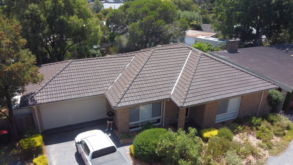 Tile roof restoration in Frankston showing freshly sealed ridge capping.