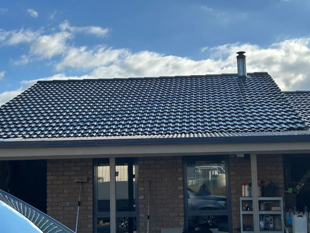 Epping property after roof repair, with repaired leak zones, restored ridge lines, and tiles coated to match the original roof colour.