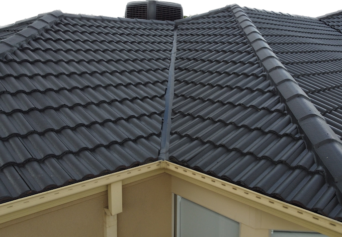Close-up of a repaired tiled roof in Keilor, highlighting sealed valleys and neatly aligned black roof tiles.