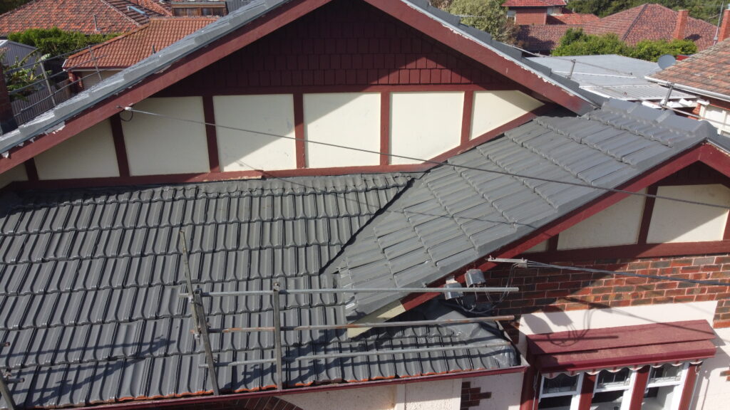 Close-up of a heritage-style home in Bentleigh East with freshly repaired grey tile roofing and restored ridges above decorative timber façade.