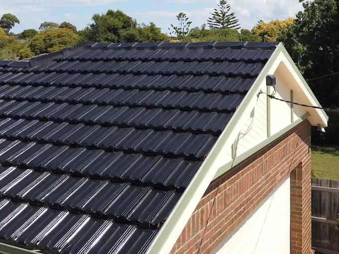 Repaired and freshly painted black tile roof on a Glen Waverley home, showing restored tiles and clean finish.
