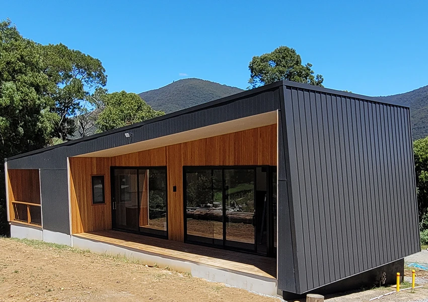 Modern Melbourne home with wood, metal cladding, roofing repair info.