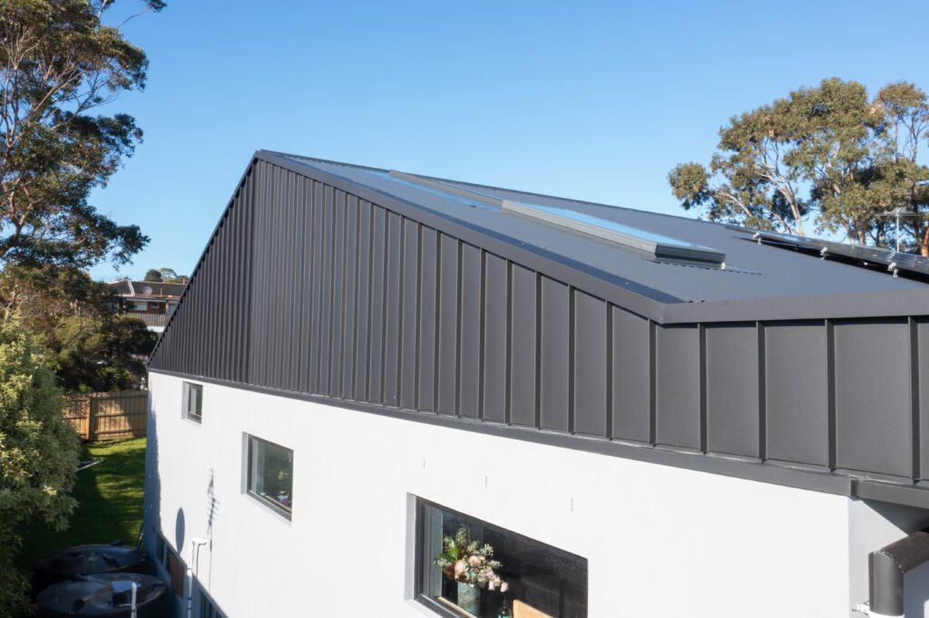 Modern Melbourne home with restored gray metal roof and skylights.