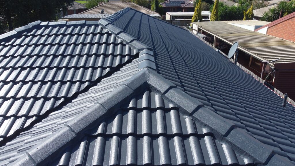 Modern Melbourne roof with glossy tiles, ridge repair restoration.