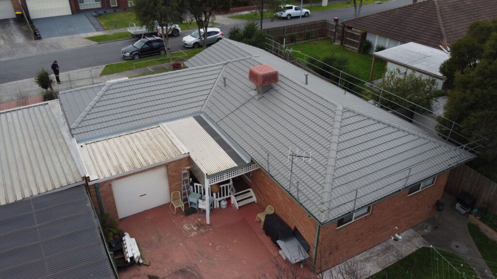 Aerial view Melbourne home, gray roof needing repair and restoration.