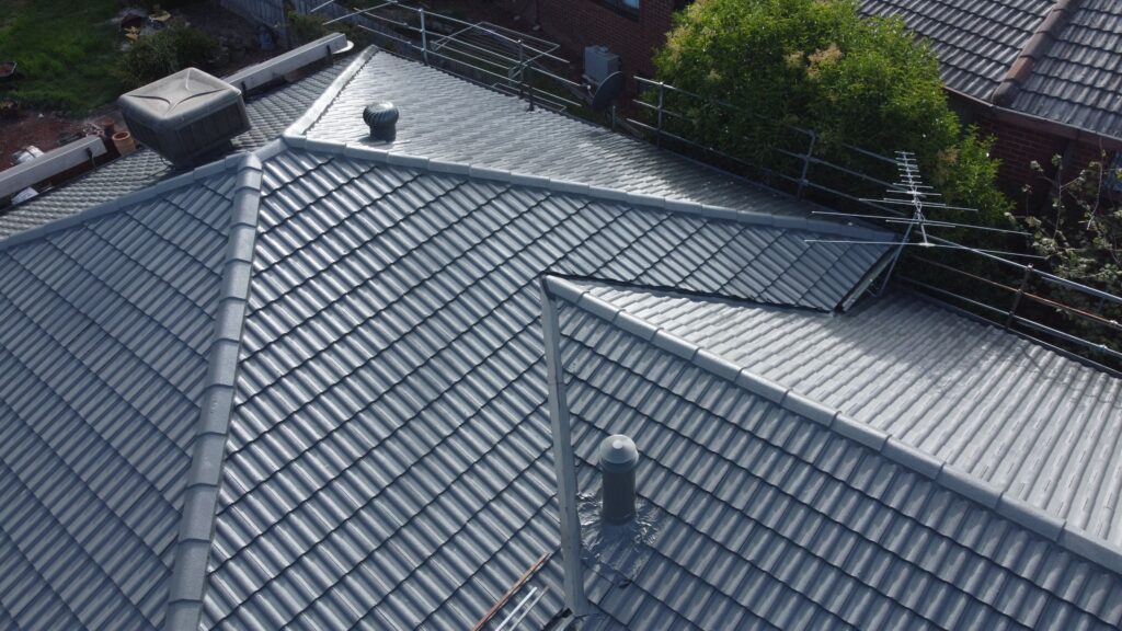 Melbourne house roof with tiles, vents, antenna, restoration.