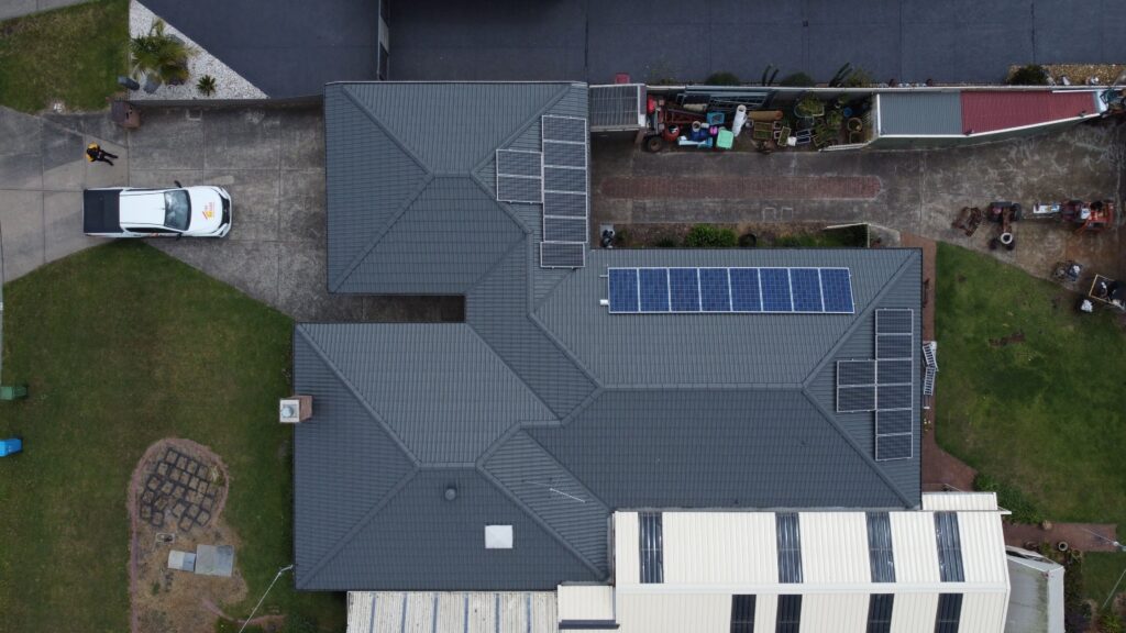 Aerial of Melbourne house with solar panels, driveway, roof repair potential.