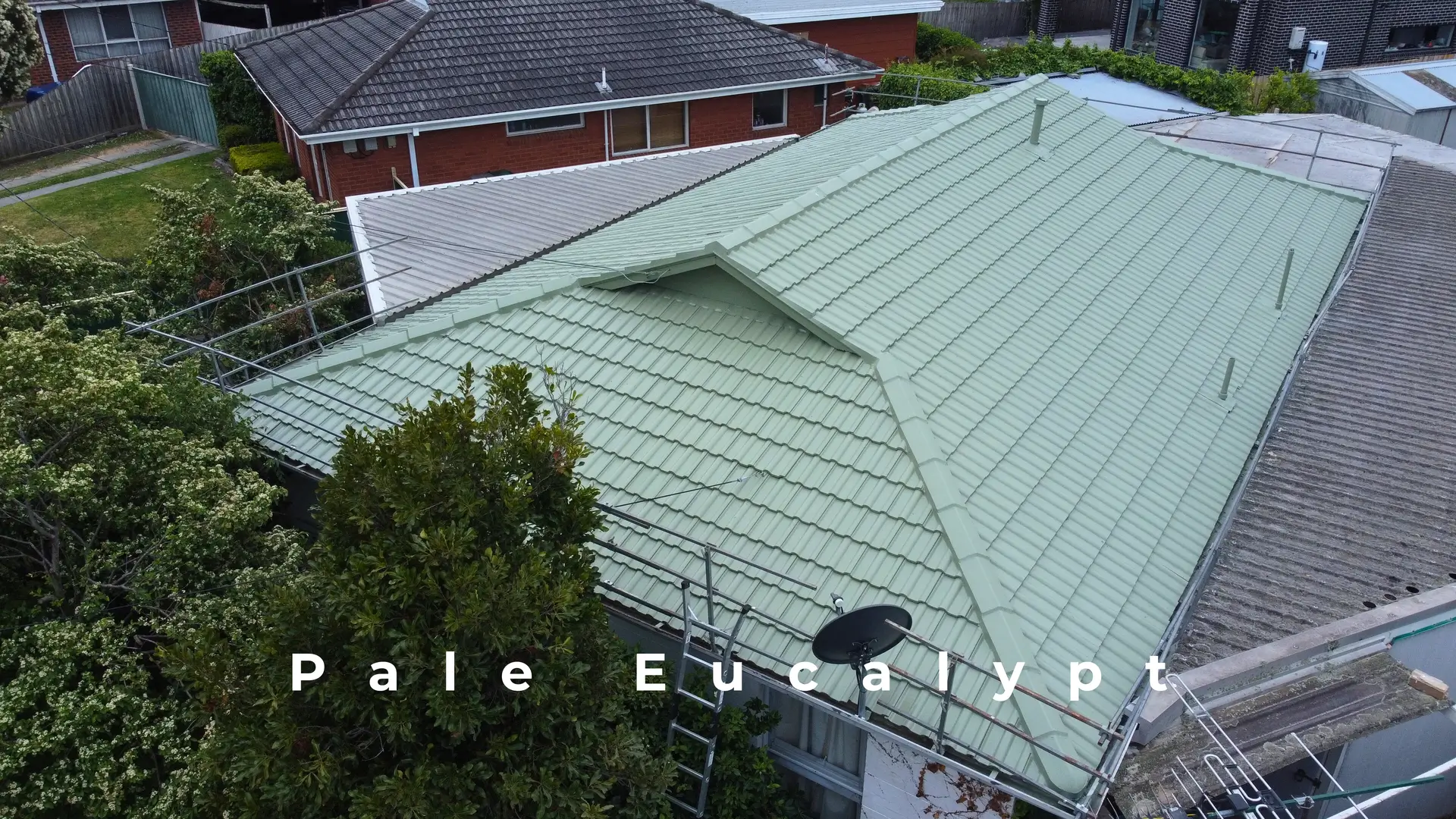 Melbourne roof restoration: pale eucalyptus tiles, scaffolding visible.
