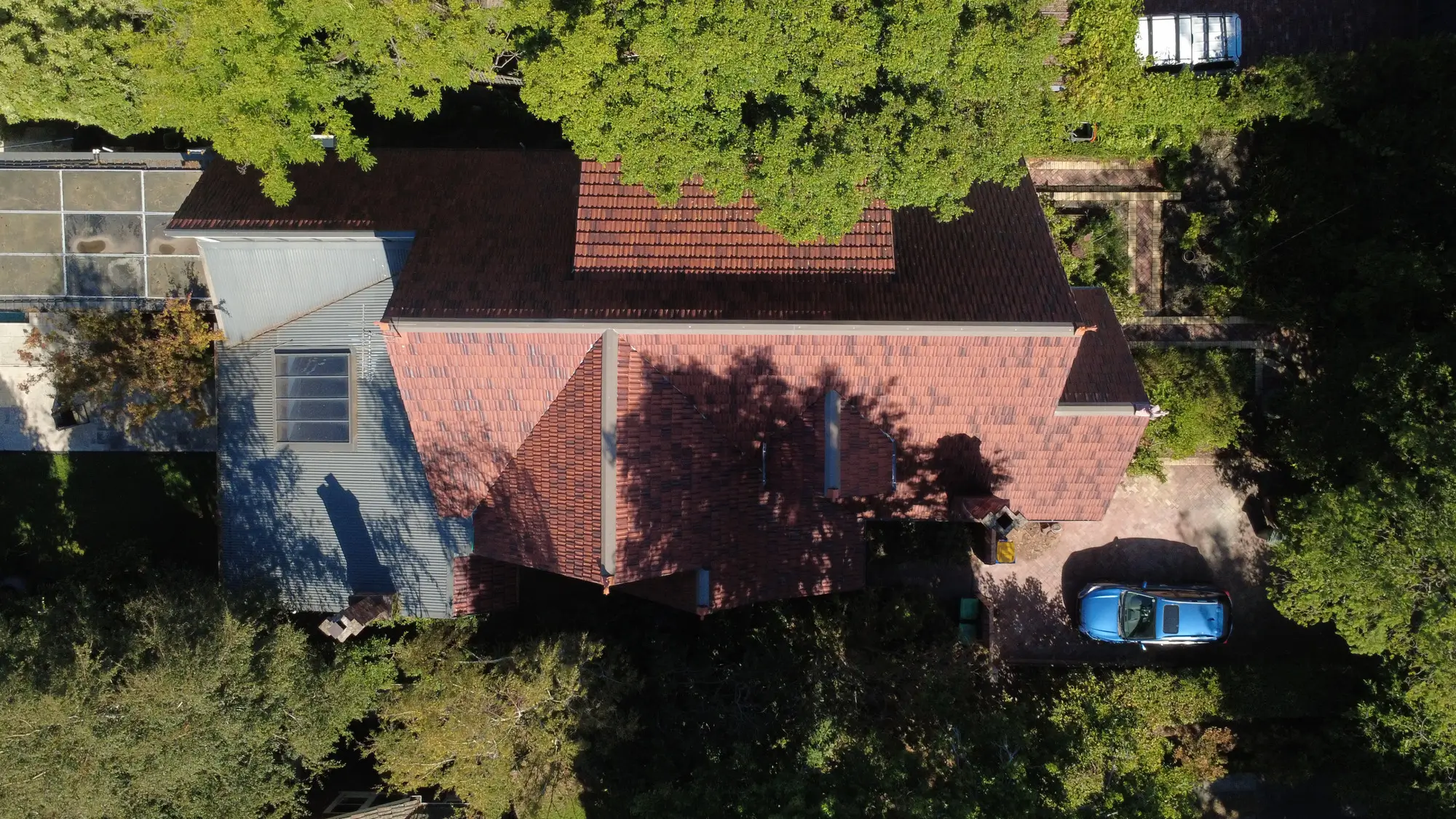 Aerial view of Melbourne home with red-tiled roof restoration.