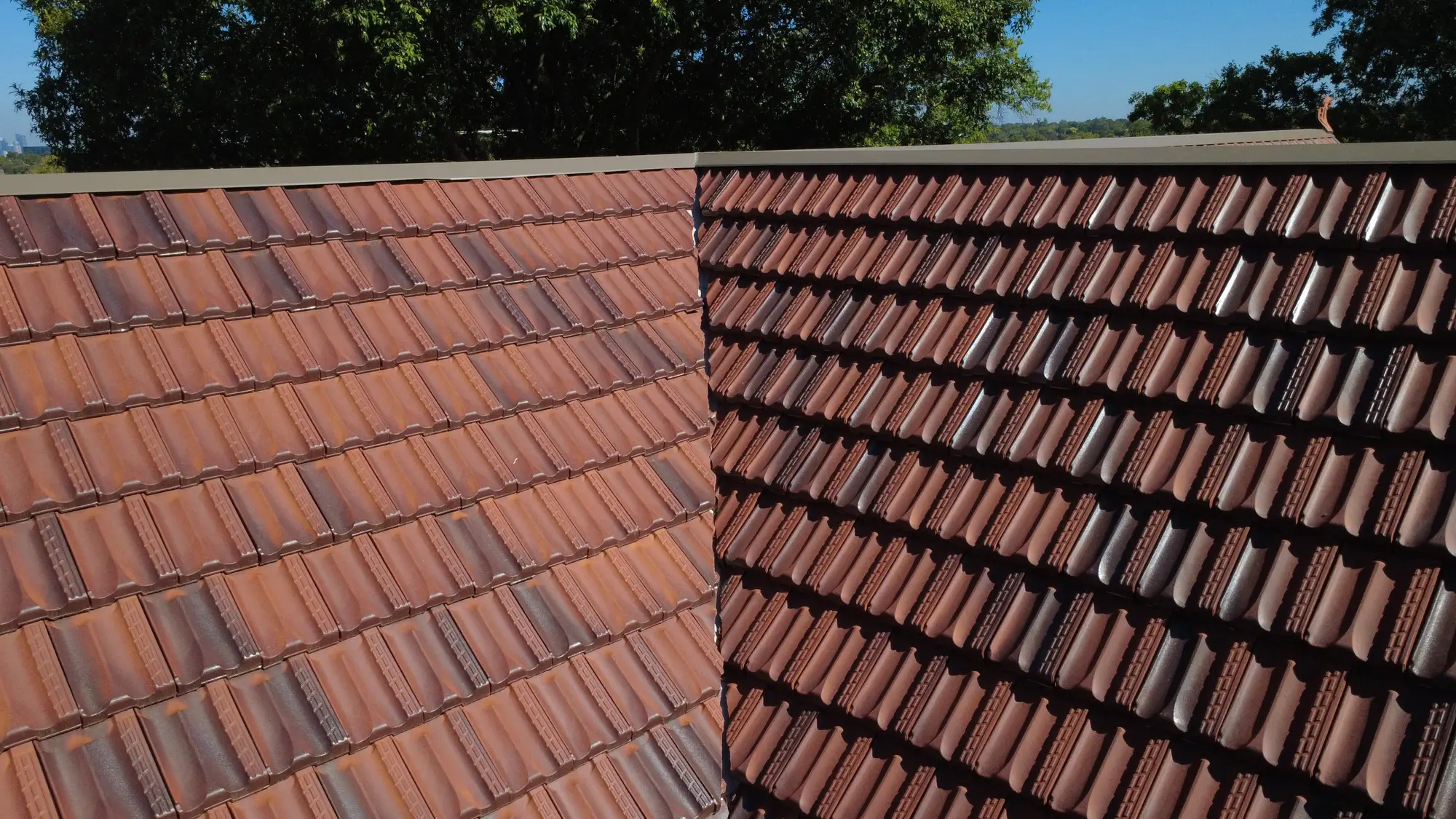 Melbourne roof restoration: intersecting clay tiles, blue sky.